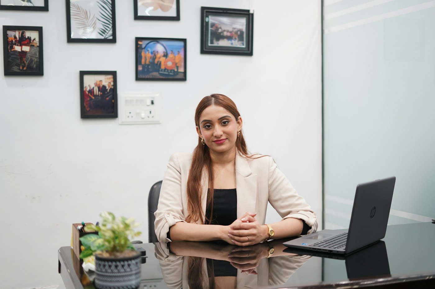 An HR executive smiling at her desk.