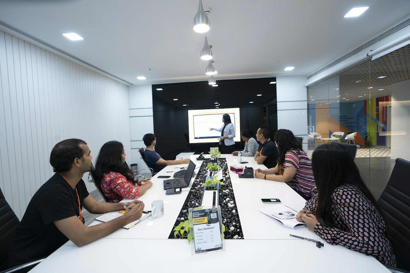 A team in a meeting room listening to a presentation.